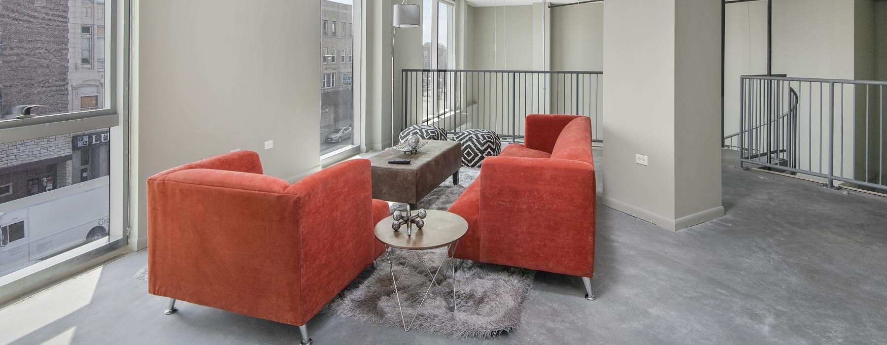 a living room with red chairs