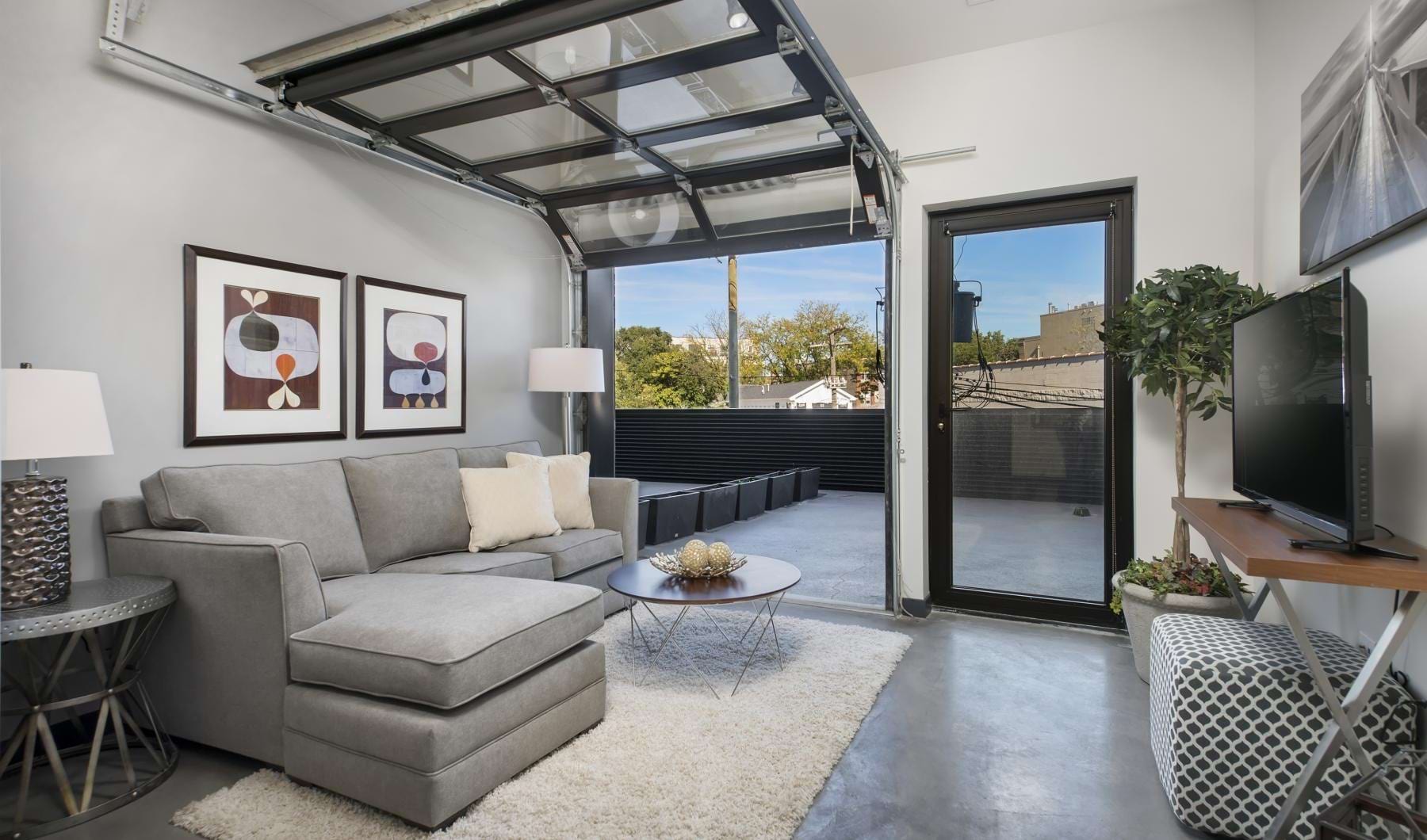 a living room with a garage style door