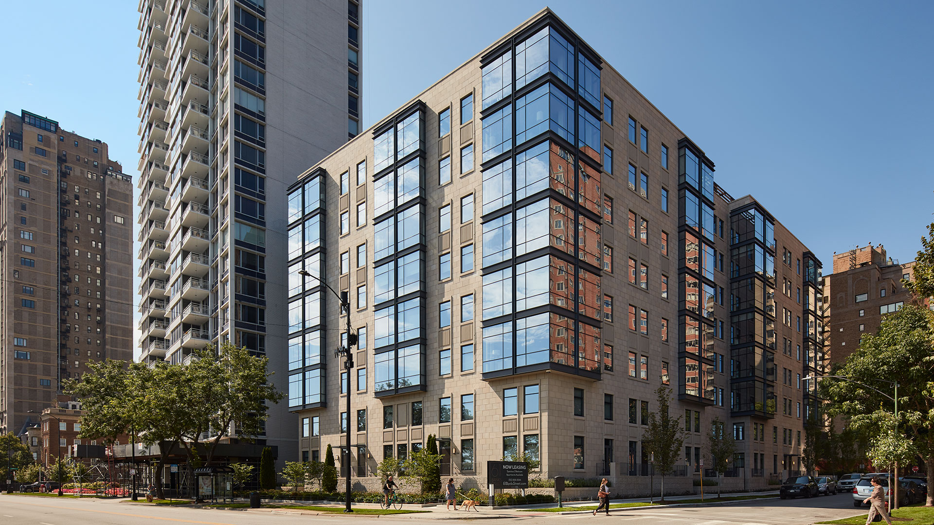 The exterior of 61 Banks Street from across Lake Shore Drive looking west down Banks Street on a clear sunny day.