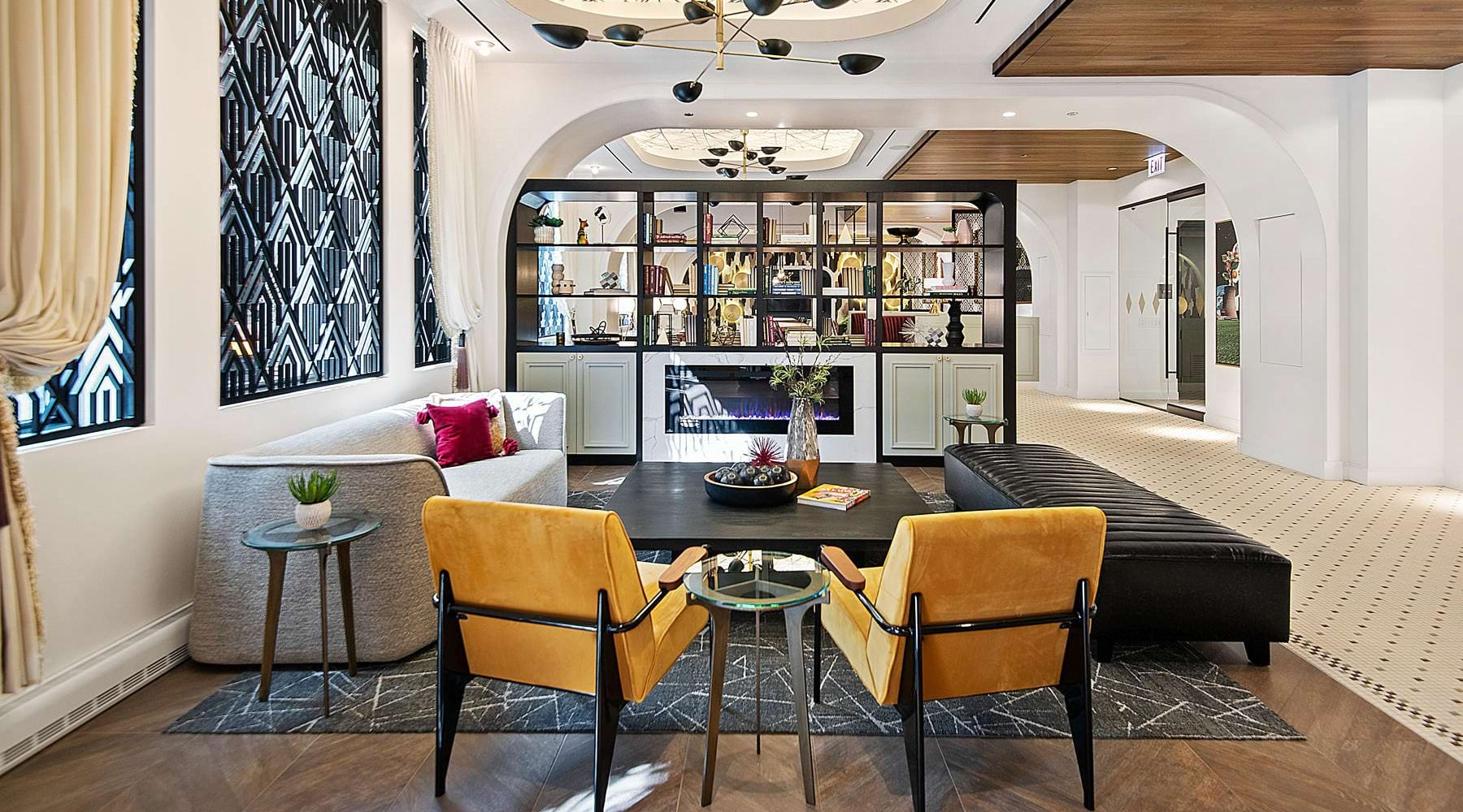 Resident clubhouse with ample seating, fireplace, demo kitchen and TVs
