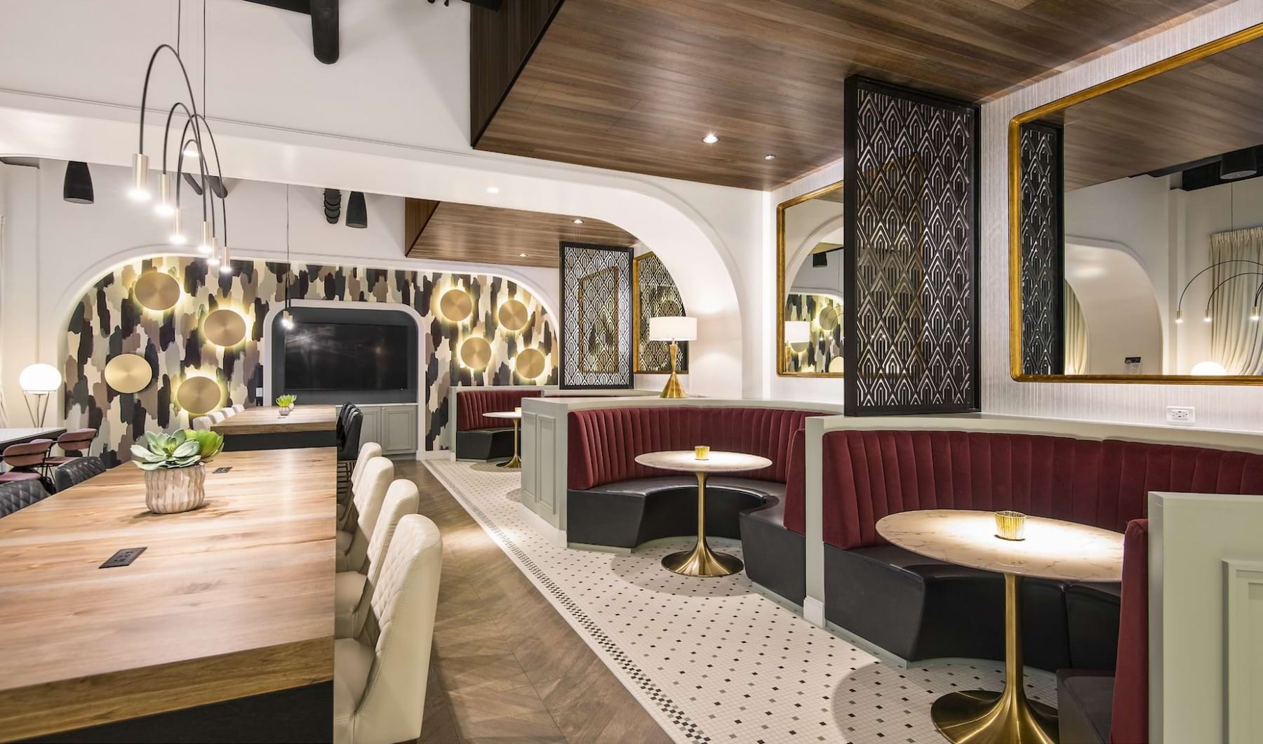 Resident clubhouse with ample seating, fireplace, demo kitchen and TVs