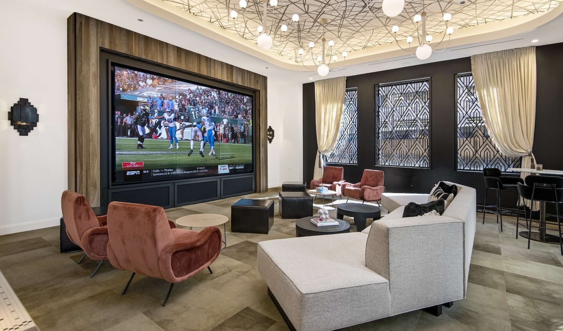 Resident clubhouse with ample seating, fireplace, demo kitchen and TVs