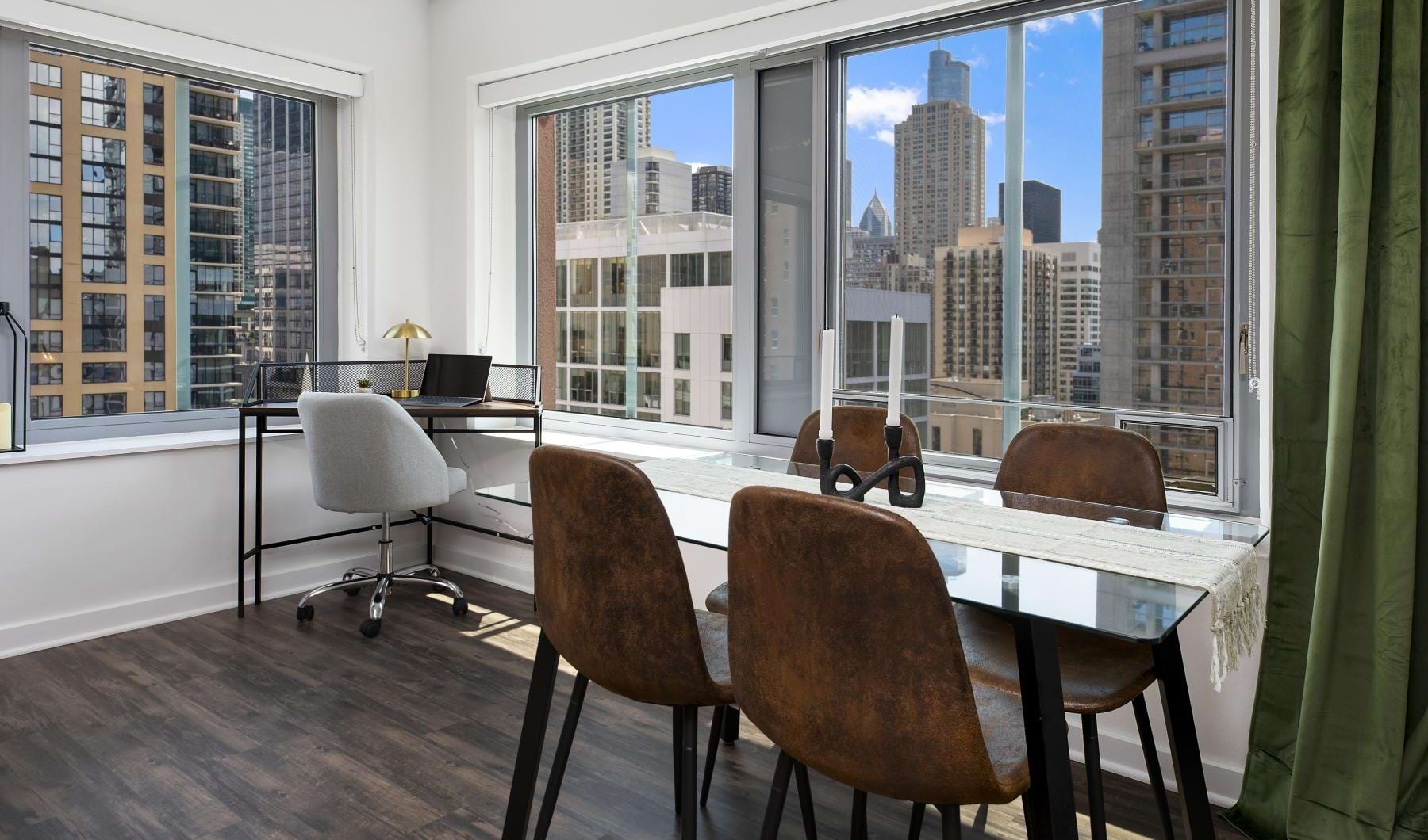 Chestnut Tower apartment dining area and home office surrounded by large Chicago-facing windows