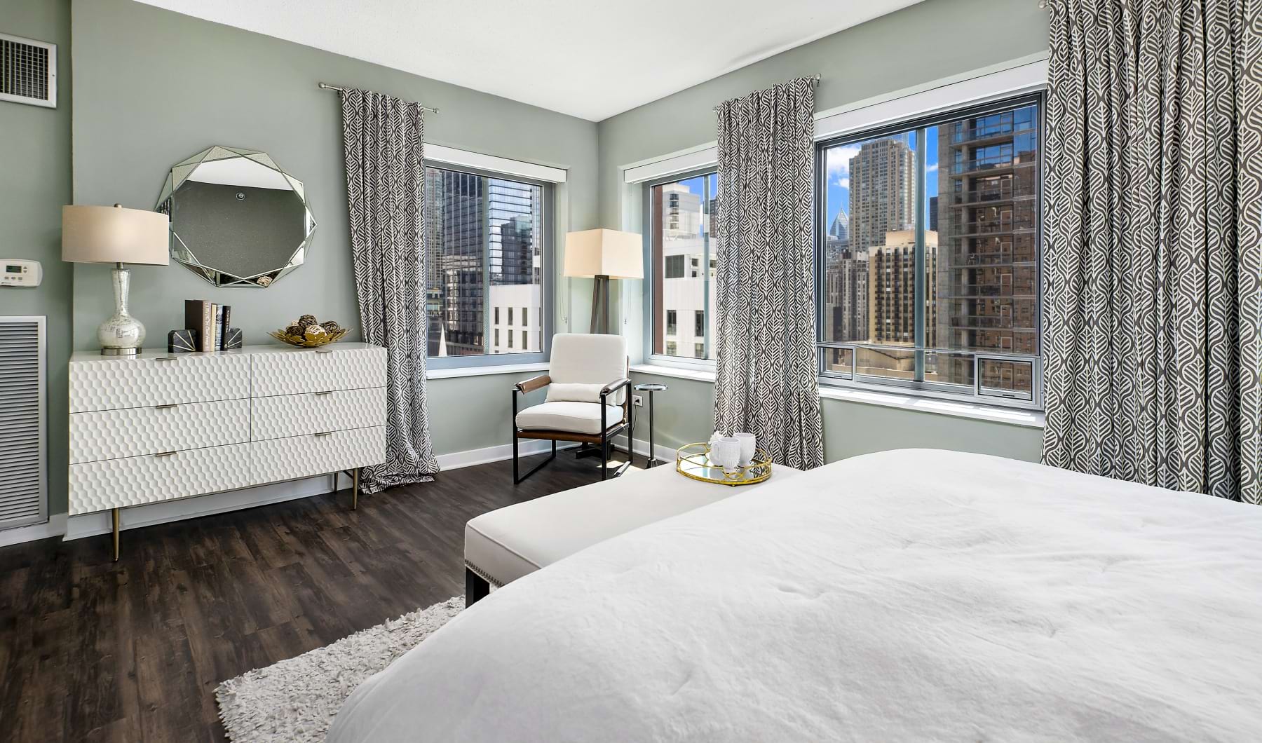 Spacious Chestnut Tower apartment bedroom with corner windows and downtown Chicago views
