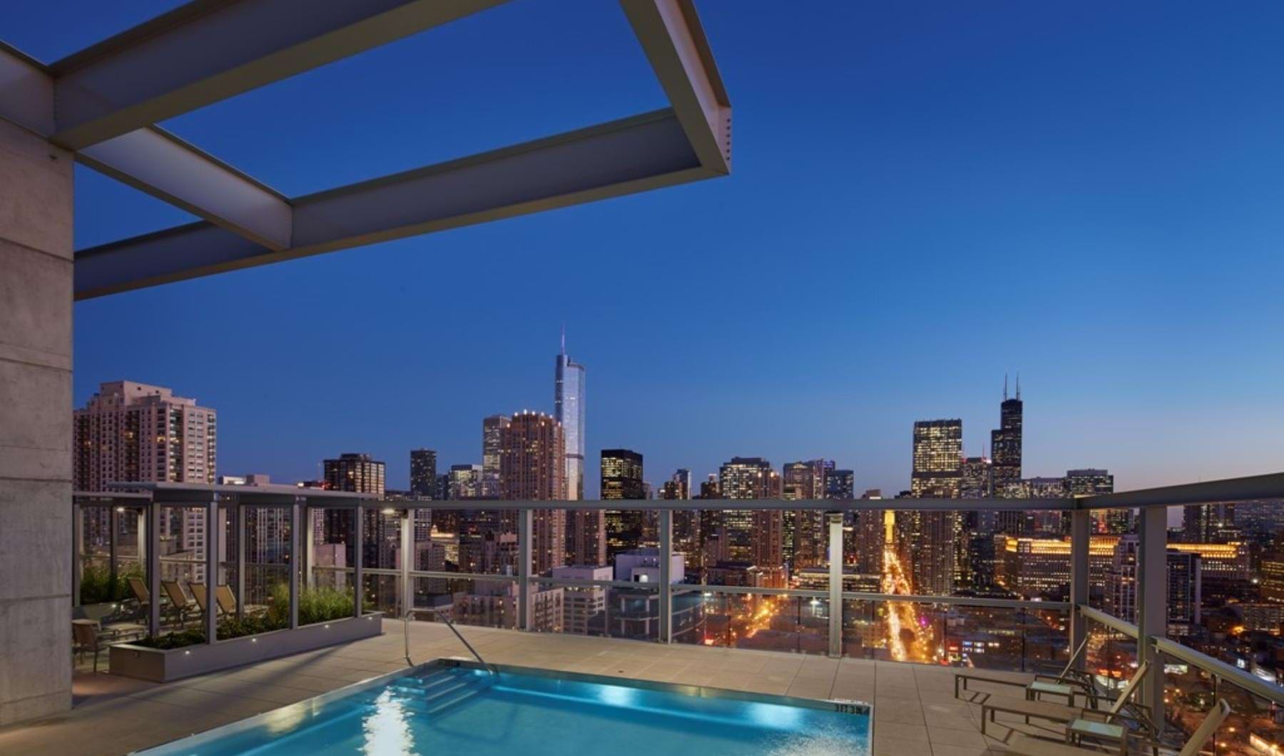 a pool with a city skyline in the background