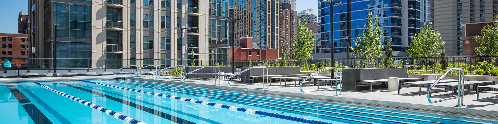 Outdoor lap pool and sundeck with Chicago skyline views at Exhibit On Superior