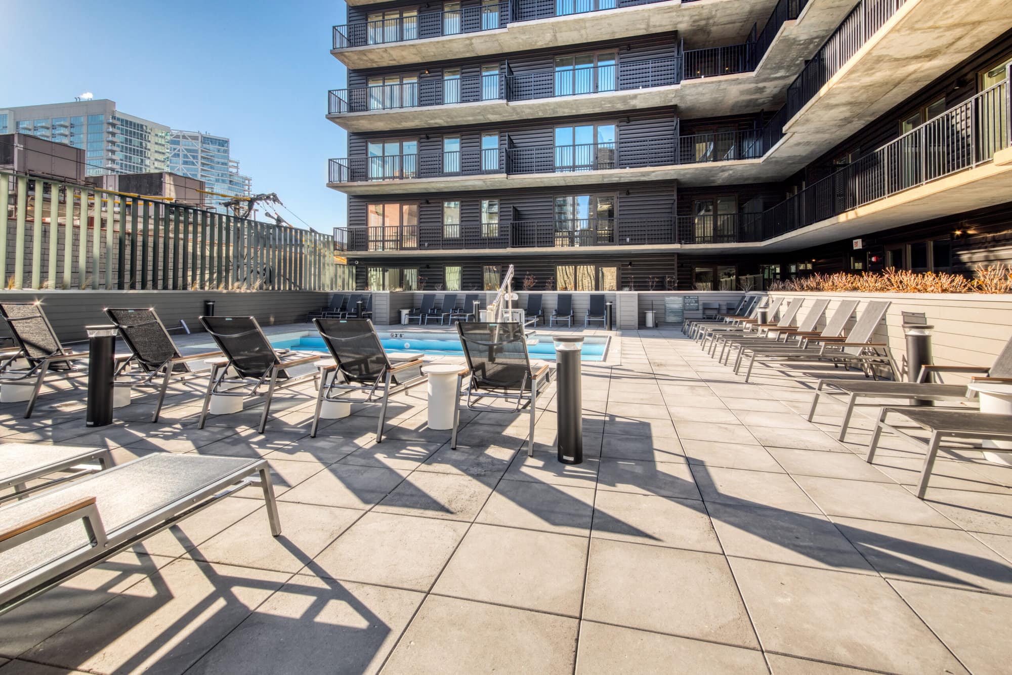 -MG-7201 Pool deck with lounge chairs at Hugo apartments