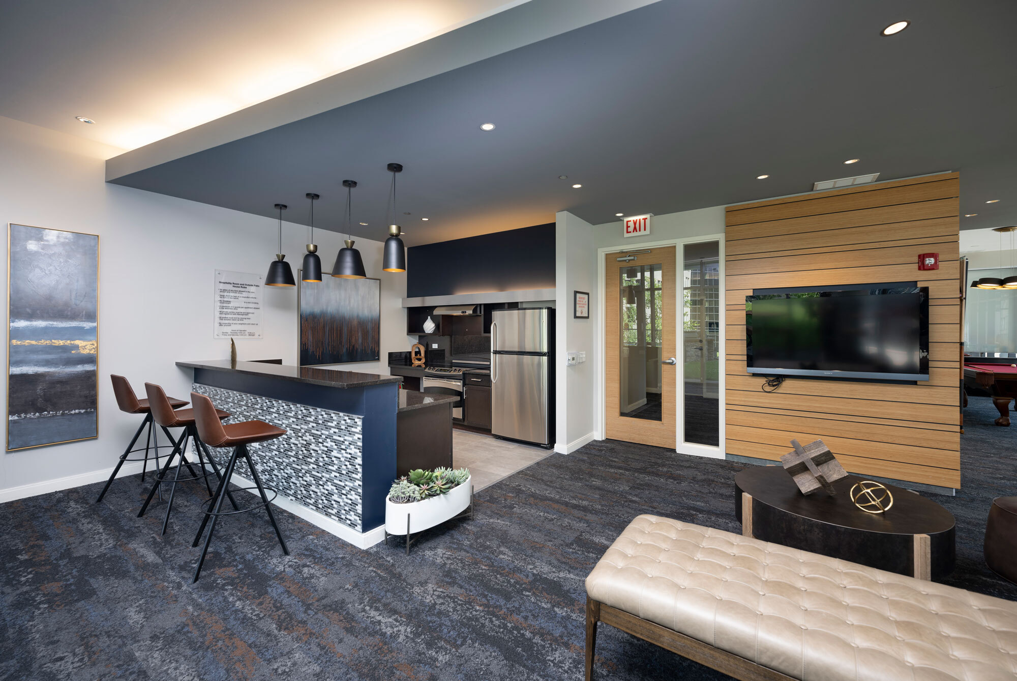 Clubhouse at Lake & Wells with a TV and barstools in our Chicago apartments.