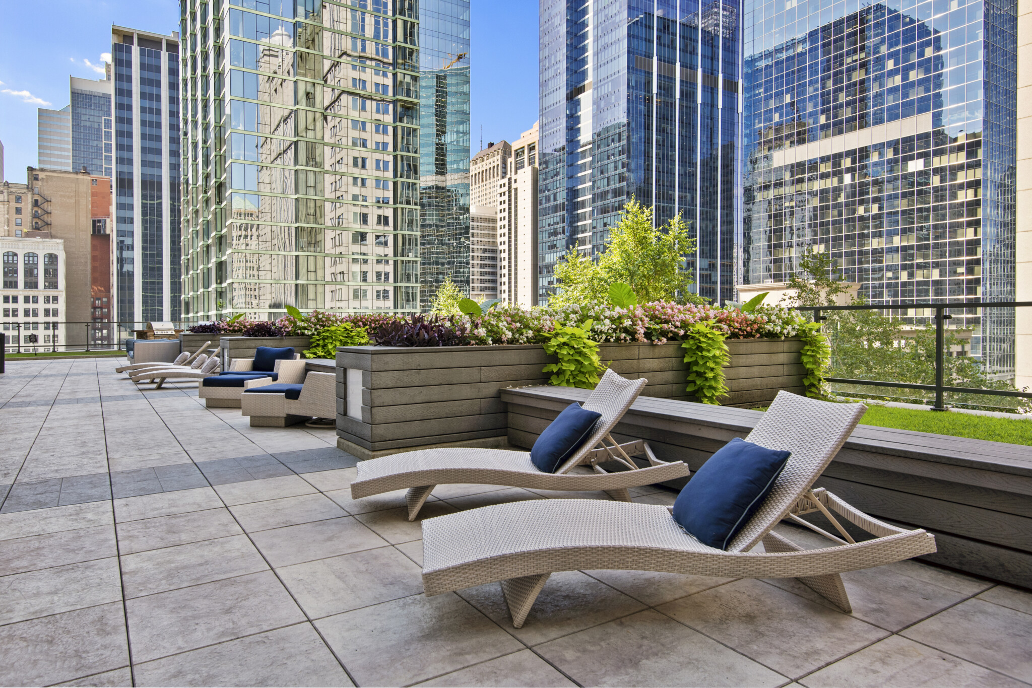outdoor lounge chairs with city buildings in background