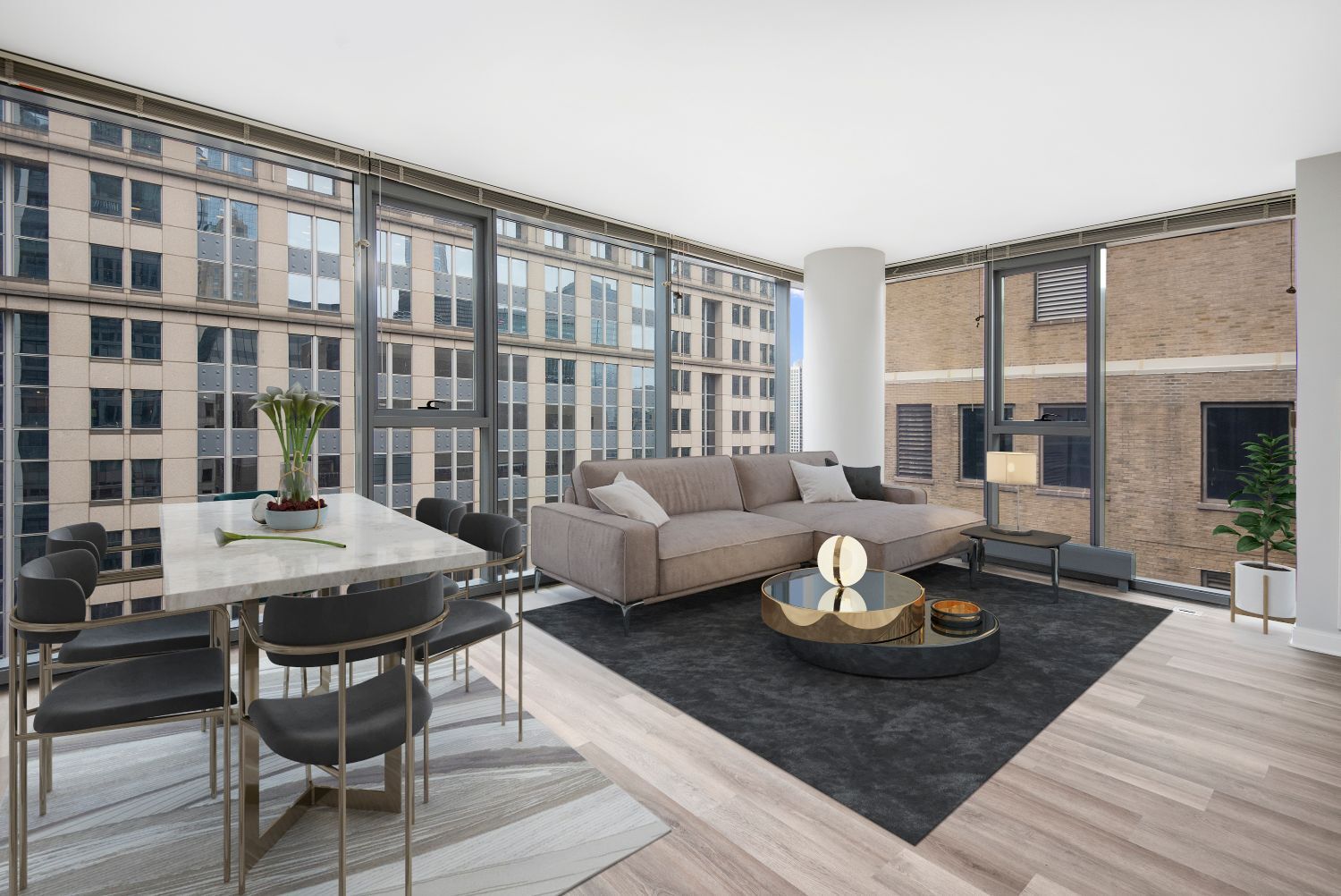 Apartment in Chicago, IL common area with grey couch and large floor to ceiling windows at Lake & Wells.